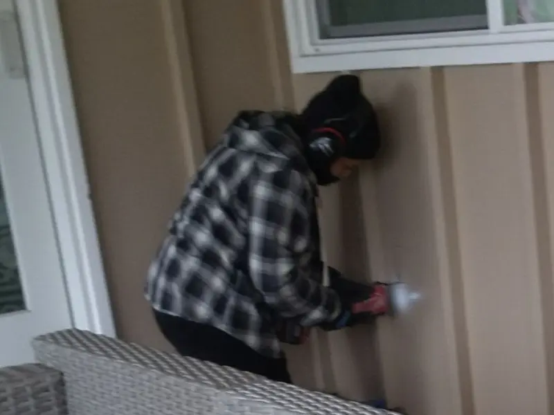 Professional electrician installing an exterior outlet in Royalton